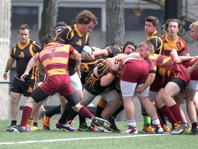 Players from the La Salle Black Knights battle for yardage against the Regiopolis-Notre Dame Panthers during the Kingston Area Secondary Schools Athletic Association senior boys rugby championship game at Nixon Field on the Queen’s University campus on Thursday. (Ian MacAlpine/The Whig-Standard)