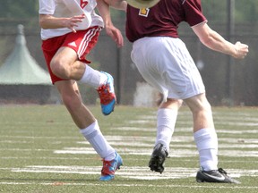 Sydenham Golden Eagles’ Patrick Russell, left, tries to get by
Regiopolis-Notre Dame Panthers’ Ryan Fox during the Kingston Area Secondary Schools Athletic Association senior boys soccer championship at Queen’s University’s West Campus on Thursday. (Ian MacAlpine/The Whig-Standard)
