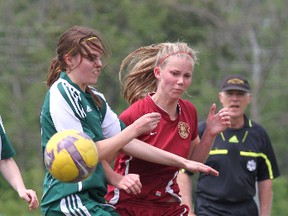 Holy Cross Crusaders’ Devan Anderson, left, battles for the ball with Regiopolis-Notre Dame Panthers’ Sadie Morris during the Kingston Area Secondary Schools Athletic Association senior girls soccer final at Queen’s University’s West Campus on Thursday. The Panthers won the game 2-0. (Ian MacAlpine/The Whig-Standard)