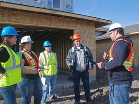 Daytona Homes construction manager Andy Rosevear explains inspection procedure to (left to right) Bobbi Moman, Tyla Savard, Wayne Arlidge and Kevin Pederson at the Grande Prairie Region Canadian Home Builders Association’s Inspection Jobsite Program launch on Thursday. The association completed its first inspection on a Royal Oaks Drive residence, identifying the risks and hazards that could impact worker and community safety.
Elizabeth McSheffrey/ Daily Herald-Tribune