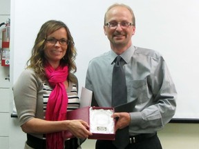 Donna Mestdagh-Mueller, strategic initiatives learning coordinator, receives the Excellence Award from board chair Preston Meier during Thursday's school board meeting held at North Memorial School. (ROBIN DUDGEON/PORTAGE DAILY GRAPHIC/QMI AGENCY)