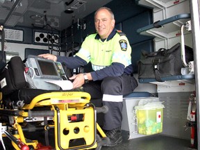 Primary care paramedic Ron McGregor retired after 38 years in the emergency health care field in Chatham, Ontario on Friday, May 24, 2013. McGregor is checking a cardiac monitor/defibrillator inside an ambulance at the Doug Arbour EMS headquarters. (VICKI GOUGH, Chatham Daily News)