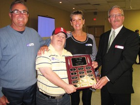 Dan Thorner, left, and his wife Roben Thorner were honoured Friday with the 2013 Hero Award from Community Living Sarnia Lambton. With them is Doug Leckie who met the Thorners as a student at St. Clair Secondary School 30 years ago. Chris King, right, a community living board member, presented the award at the 11th annual Mayor's Luncheon. (CATHY DOBSON, The Observer)