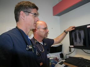 Dr. Trevor Harterre, left, one of the emergency room physicians at Timmins and District Hospital, examines X-rays with physician assistant Shawn Best. Since its introduction as a pilot project six years ago, the position of physician assistant has proven to be a great success in Timmins.