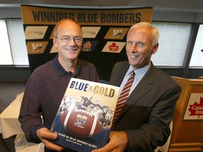 Bob Irving (left) and Bob Toogood display the new Blue Bomber book titled Blue & Gold 75 years of Blue Bomber Glory at The Blue & Gold Room on Sept. 21, 2005.