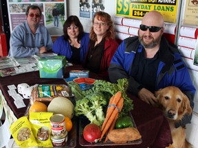 A tasty information booth was set up by the Timmins chapter of the CNIB at No Frills to promote the links between healthy nutrition and good eyesight. Among those from the CNIB discussing the benefits of healthy eyes were, from left, independent living skills specialist Dave Winchester, low vision specialist Melanie Brenn, orientation and mobility specialist Cynthia Barty, independant living skills specialist Mark Callaghan, and Callaghan's trusty golden retriever Javon.