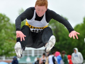 Reuben Smith of La Salle Secondary School stretches out in the midget boys long jump competition at the Eastern Ontario Secondary Schools Athletic Association track and field championships in Brockville on Friday. Smith finished second in the event. (Darcy Cheek/QMI Agency)