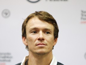 Kingston's Simon Whitfield has scaled back his training schedule and will compete in a 10km run in Calgary on Sunday. (QMI file photo)