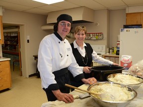 OSHaRE cook James Skarnikat and operations director Peggy Moulaison prepare for Friday night’s dinner. The soup kitchen’s popularity is starting to raise financial concerns for the charitable organization.