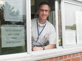 Pharmacist Harry Haramis at the drive thru window at the Medical Arts Pharmacy on Thirteenth Street. The pharmacy is trying a new business model — one hour service to fill many prescriptions. 
Staff photo/KATHRYN BURNHAM