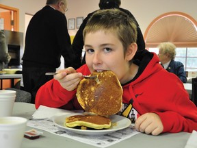 Eleven-year-old Jayson DeHaan tucks into his breakfast with the enthusiasm of an eleven-year-old during the Salvation Army’s Red Shield Breakfast fundraiser on Friday morning.