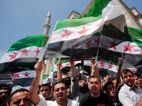 Demonstrators shout Islamic slogans as they wave Syrian opposition flags during a protest against Syria's President Bashar al-Assad at the courtyard of Fatih mosque in Istanbul May 24, 2013. (REUTERS/Murad Sezer)