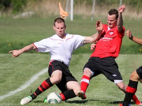 Owen Sound United's Clark Green,left, makes a sliding attempt to beat Collingwood United's Kyle Heatherington to a loose ball during York Region Soccer League senior action on Saturday, May 25, 2013 at the Kiwanis soccer complex in Owen Sound.