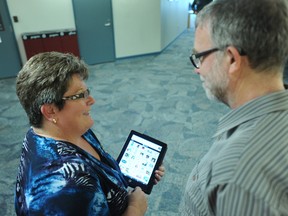 Janice Smith, coordinator of the developmental services worker program, shows an iPad app to Jim Elliott, acting vice-president academic, at Lambton College Thursday, May 23, 2013. Faculty members have spent this week receiving training on mobile learning. BARBARA SIMPSON / THE OBSERVER / QMI AGENCY