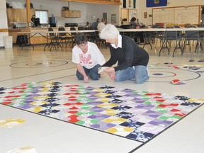 Jackie Handspiker and Loretta Chiasson lay out the squares of a quilt the hand quilting senior’s group on Tuesday, May 21 at the Seniors Circle. The group is handsewing a large quilt that they will be using as a the prize for a raffle to raise money for the Seniors Circle in the fall.
Barry Kerton | Whitecourt Star