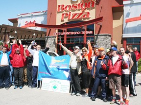 Woodstock athletes with Special Olympics Ontario, Woodstock Police Service officers and supporters celebrate the completion of Woodstock's 14th annual Law Enforcement Torch Run for Special Olympics on Saturday, May 25, 2013. Collecting thousands of dollars in pledges for local Special Olympics programs, participants ran from police headquarters on Dundas Street to Boston Pizza on Norwich Avenue where the restaurant treated them to free pizza. JOHN TAPLEY/INGERSOLL TIMES/QMI AGENCY