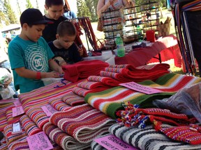 Children examine Métis sashes at Fort McMurray’s Métis Fest, held at Local 1935’s office in Gregoire. VINCENT MCDERMOTT/TODAY STAFF
