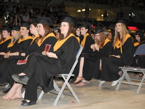 Composite High school graduates listen closely to their valedictorian as he talks about moving forward and making memories commencement ceremony at the Crystal Centre on Friday.
Elizabeth McSheffrey/Daily Herald-Tribune