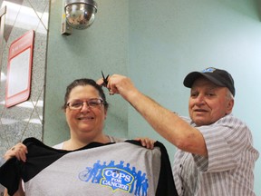 Timmins Canadian Cancer Society event co-ordinator Sandra Coupal got an idea of what those participating in Cops for Cancer will be feeling from Palace Barber Shop owner Roger Picard. The event, which will be held at the downtown Urban Park on June 27 aims to raise money to fund cancer research and programs supporting local residents affected by the disease.