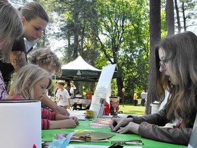 Abby, Caitlin and Benjamin Noonan get help making origami from mom, Aimee Noonan, and education instructor Deandra Mercer during the Glenhyrst Art Gallery of Brant's Family Arts Day on Sunday. (HUGO RODRIGUES, The Expositor)