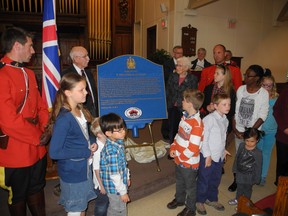 The eldest members of St. John's Presbyterian Church, Les Fouldes, left closest to plaque, and Kathleen Alguire, right, take part in the unveiling Sunday of a plaque recognizing St. John's historic link to the War of 1812. 
Greg Peerenboom staff photo