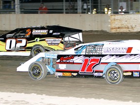 Jody Mason (02) leads Steve Shaw Jr. (17) during the Mini-Mods feature race Saturday at South Buxton Raceway. Mason led the final 15 laps to win his first feature since 2000. (JAMES MACDONALD/Special to The Daily News)
