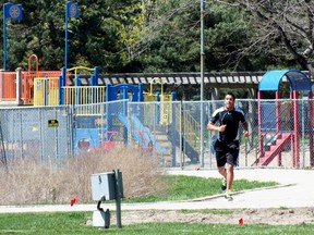 The city fenced in the beach area of the park a week after fencing off the playground. Walkers can still use the walkway through the fencing. (QMI Agency file photo)