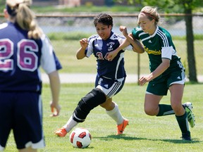 St. Theresa Catholic Secondary School Titans (blue and white jerseys) win the Bay of Quinte Senior Girls Soccer championship match 1-0 over Centennial Secondary School Chargers (green jerseys) at Zwicks Park in Belleville, Ont. Monday afternoon, May 27, 2013.  JEROME LESSARD/The Intelligencer/QMI Agency