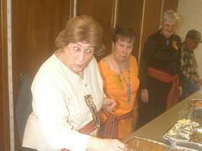Wallaceburg's Ida DeBusschere serves some food during the Metis Culture celebration held on Sunday at the Knights of Columbus Hall. Beside DeBusschere is Diane Burtch. The celebration was sponsored by the Fiddle and Sash Association. It was the fifth year for the event, which celebrates Metis culture. Along with displays of Metis culture, there were many Metis delicacies for people to sample.