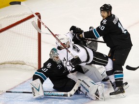 Los Angeles Kings center Colin Fraser (24) is hit into San Jose Sharks goalie Antti Niemi (31) by Andrew Desjardins (10) in the 2nd period during Game 4 of their NHL Western Conference semifinal playoff hockey game in San Jose, California May 21, 2013. REUTERS/Robert Galbraith (UNITED STATES - Tags: SPORT ICE HOCKEY)