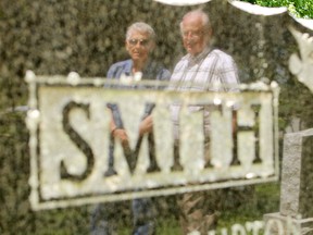 Brothers Carmon and Allan Smith, pictured here reflected in their parents' tombstone, had to win in court for the right to be buried in Cataraqui Cemetery plots that have been in their family since 1869.
Elliot Ferguson The Whig-Standard