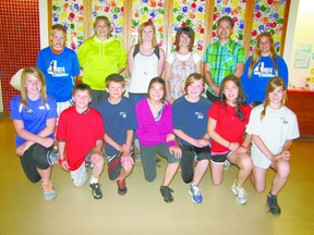 Gathered for a run, the Elmer Elson Elementary School participants in the Fallen 4 Marathon uphold a tradition of fielding four-person relay runners which teachers Nolan Andriuk, Brenda Henrikson and Tammy Davis began in 2009 and which teachers continue to organize. Runners and organizers are, from left, back row,  Chase Langdale, teacher Tammy Davis, teacher Erica MacLean, teacher Leanna Hagman, teacher Nolan Andriuk, Lauren Shaw, and, front row, left to right Hannah Williams, Jason Roberts, Spencer Roszko, Shayla Medley, Taylor Bond, Merasia Loughran, Michaela Paskal.