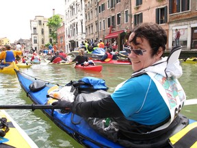 Liz Lamb, one of two women who will be making a five-week kayak trip on the St. Lawrence River in June, sits in her kayak while in Venice earlier in the month for a race around the Venetian islands.