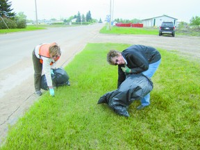 Linda Smith, left, and Kate Patrick pick up trash from a Mayerthorpe boulevard along Highway 22  near  52 Avenue.