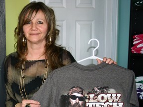 JEFF TRIBE QMI Agency
Colleen Stobbe shows off one of her favourite Duck Commander t-shirts, offered at her retail outlet, Shear Creations Gift Shoppe, just north of Port Rowan on Highway 59. Stobbe has found all things Duck Commander to be popular items.