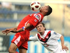Nik Ledgerwood, right, shown here in action in 2011 against Panama, says 12-hour flights are part of the gig of playing on the Canadian team. (Reuters)