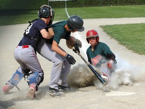 North Park's Taylor Tregoniny appears to steal home during the Brant County high school boys final Monday. But with Ryan Stephenson in the batter's box, colliding with Assumption catcher Reese Doumani, the umpire called the batter out, and the runner was told to go back to third base. (DARRYL G. SMART, The Expositor)