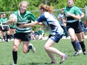 Grey Highlands' Katie Hiltz fends off Kaitlin Smith of the St. Mary's Mustangs during the Lions 29-12 win in the CWOSSA A/AA girls rugby final on Monday at Sacred Heart High School.