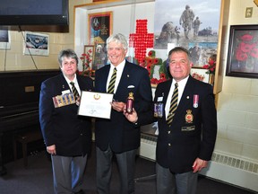 Carolyn McCaul, chairwoman of public relations with the Royal Canadian Legion's Ontario Command, left, and deputy district commander Stan Halliday, right, present former Pembroke councillor and long-time community volunteer Romeo Lavasseur with a Queen Elizabeth Diamond Jubilee Medal in the Branch 72 lounge. Levasseur, who has been an active volunteer in the community at a variety of levels and in many different functions, said the medal was a special honour since he has childhood memories of serving in the Cubs honour guard during a visit to Ottawa by then-Princess Elizabeth.