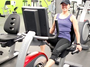 Magnum Total Fitness officially opened on May 15, 2013 at its new location at 911 Queen St. Julie Courtney works out at the gym in between teaching a spin class. (ALANNA RICE/KINCARDINE NEWS)