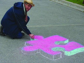 Guy Wales, 3-D chalk artist, begins a pop-up puzzle during the fifth annual Chalk The Walk event in Gananoque.          David Ansley - For the Gananoque Reporter