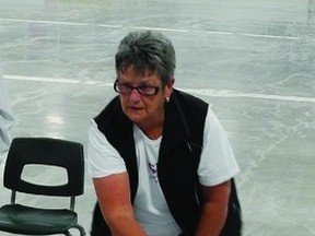 Madolyn McMahon tries her hand at a game of shuffleboard last week at the arena.  Shuffleboard is just one of the many recreational activities being offered by the town for seniors in the area.         Wayne Lowrie - Gananoque Reporter