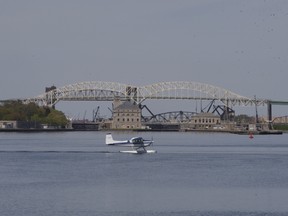 A float plane drifts past the International Bridge on the St. Marys River on Monday. The river between the twin Saults has been increasing in traffic as the seasons drift from spring towards summer.