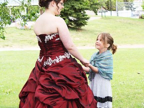 This little girl admires the gown worn by Koosha Bradley-Burger during grad weekend held this past weekend in Wetaskiwin.