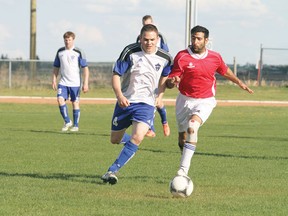 Manluk FC’s Craig Murphy, left, and Leduc FC’s Ammer Kahanfan chase down the ball during a match at Norm Brown Field May 26. Manluk went on to win 4-2, with Murphy scoring twice.