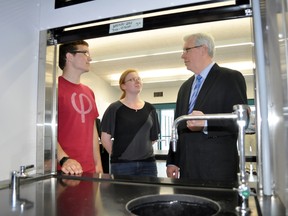 Manitoba Premier Greg Selinger discusses the features of a new chemistry lab with Portage Collegiate students Stewart Wilcox and Paige van der Zweep. (CLARISE KLASSEN/PORTAGE DAILY GRAPHIC/QMI AGENCY)