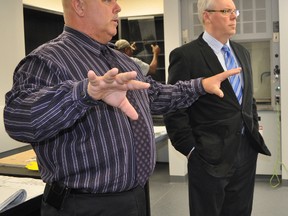 Portage Collegiate vice principal Mark Diboll, left, gives Premier Greg Selinger a tour of a chemistry lab on May 24. Selinger took time that to address spring flooding in Manitoba. (CLARISE KLASSEN/PORTAGE DAILY GRAPHIC/QMI AGENCY)