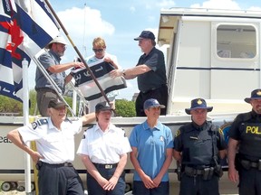 L-R: Malcolm Young, Maureen Couture, Gordon Cale, Herb Paetzold, Peggy Griffin-Paetzold, Allison Hooper, Phil Stroeder, Ken Roppel, and Bill McKeag were all on hand for the Flag Relay at the Kincardine Marina on May 20, 2013. The Kincardine Power and Sail Squadron, with the support of the Fish Kincardine Derby and the Town of Kincardine, joined in with the Canadian Power and Sail Squadron's celebration of teaching safe boating skills for 75 years. (JULIA HERRICK/KINCARDINE NEWS FREELANCE)
