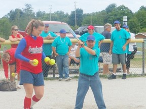 Fastball teams, as well as, members of the Special Olympics Team participated in a  skills competition during last year’s tournament. Pictured is Heather Robinson and Jason Scott, Special Olympian getting ready to take part in last year’s competition.