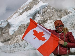 Ridgetown native Heather Geluk, 37, proudly holds a Canadian flag after being one of only a small number of Canadian women to successfully climb Lhotse, the fourth highest mountain in the world, which is situated along side Mount Everest in Nepal. She reached the summit in the early hours of May 22, 2013.
CONTRIBUTED/ THE CHATHAM DAILY NEWS/ QMI AGENCY